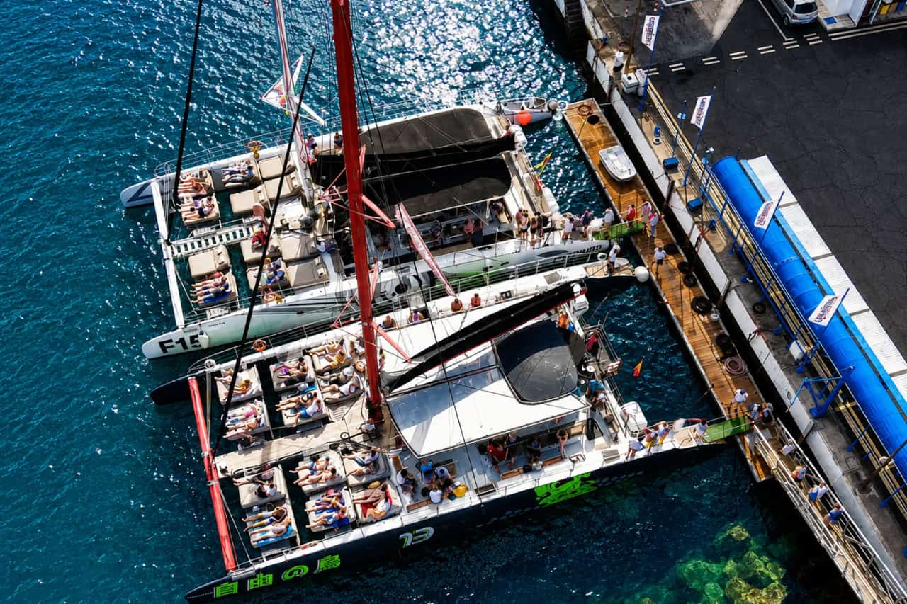 Aerial view of Freebird catamarans at the marina in Tenerife, where groups can hire a Freebird catamaran privately for events and celebrations.