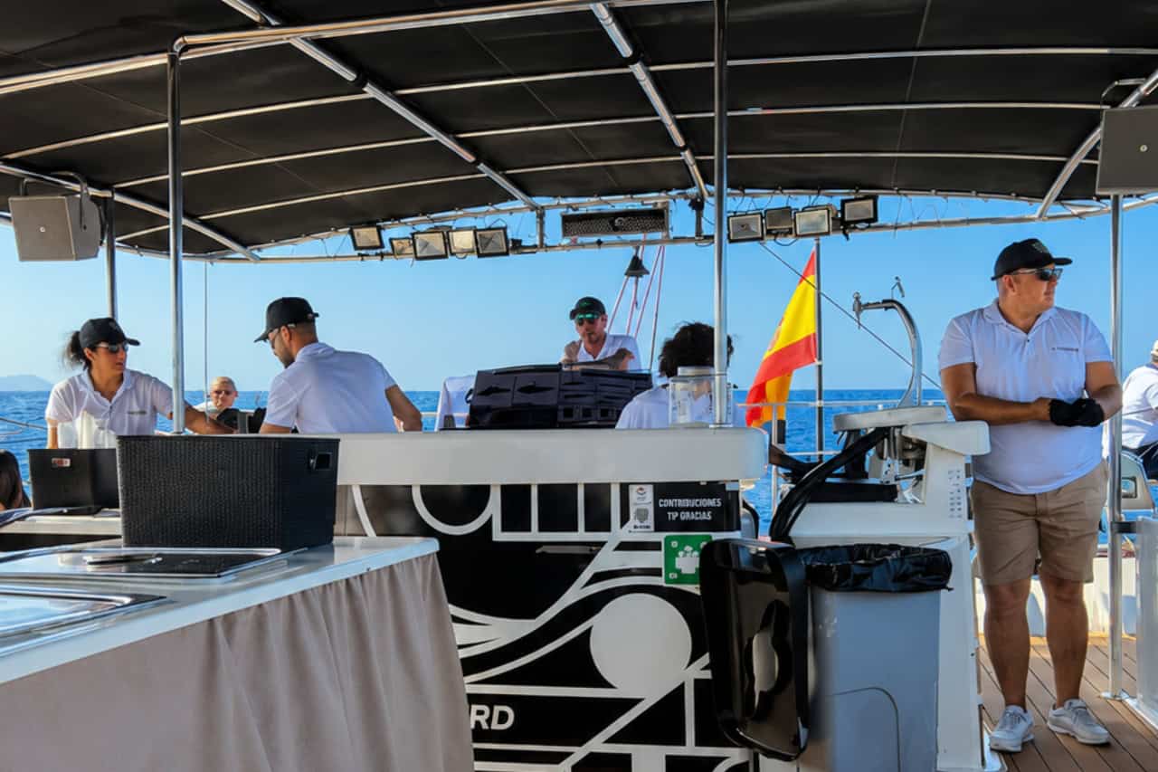 Crew and service area on board a private Freebird catamaran in Tenerife, with bar service available during private group charters.
