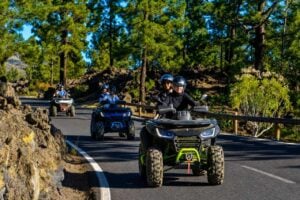 Group of riders enjoying a guided quad safari in Tenerife through scenic forest roads and volcanic landscapes.