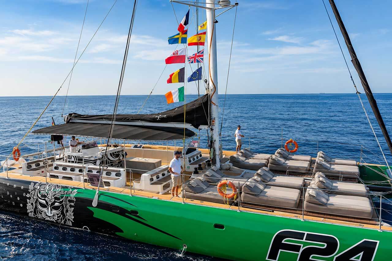 Spacious Freebird F24 catamaran cruising in Tenerife with large VIP sunbeds, shaded seating and open Atlantic views