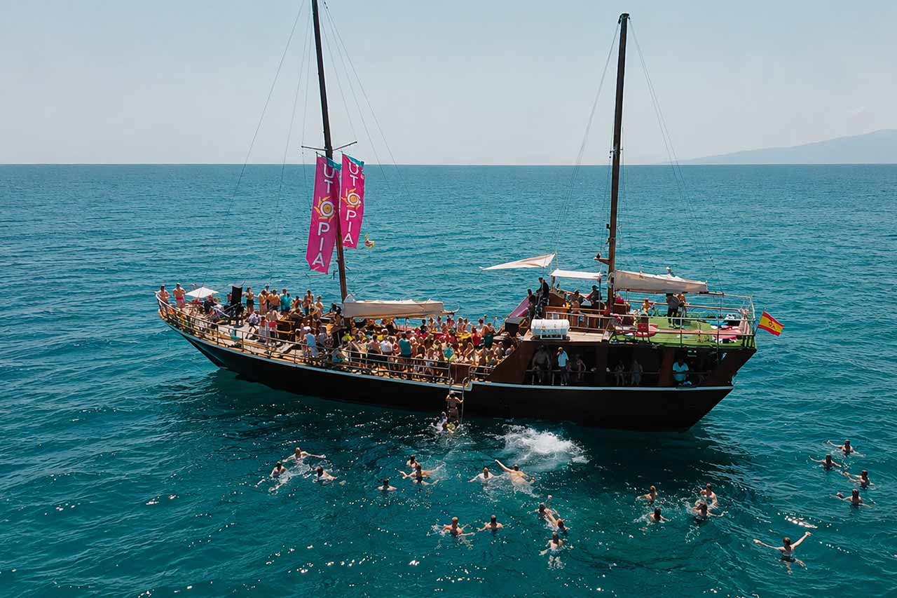 Guests swimming beside the Utopia party boat during a refreshing stop in the waters off Tenerife.