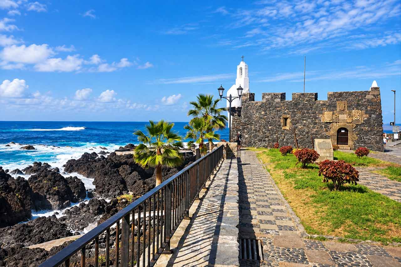 Garachico's volcanic shoreline and historic waterfront show how the town was transformed by an eruption and became known for its dramatic lava-rock coast and natural pools.