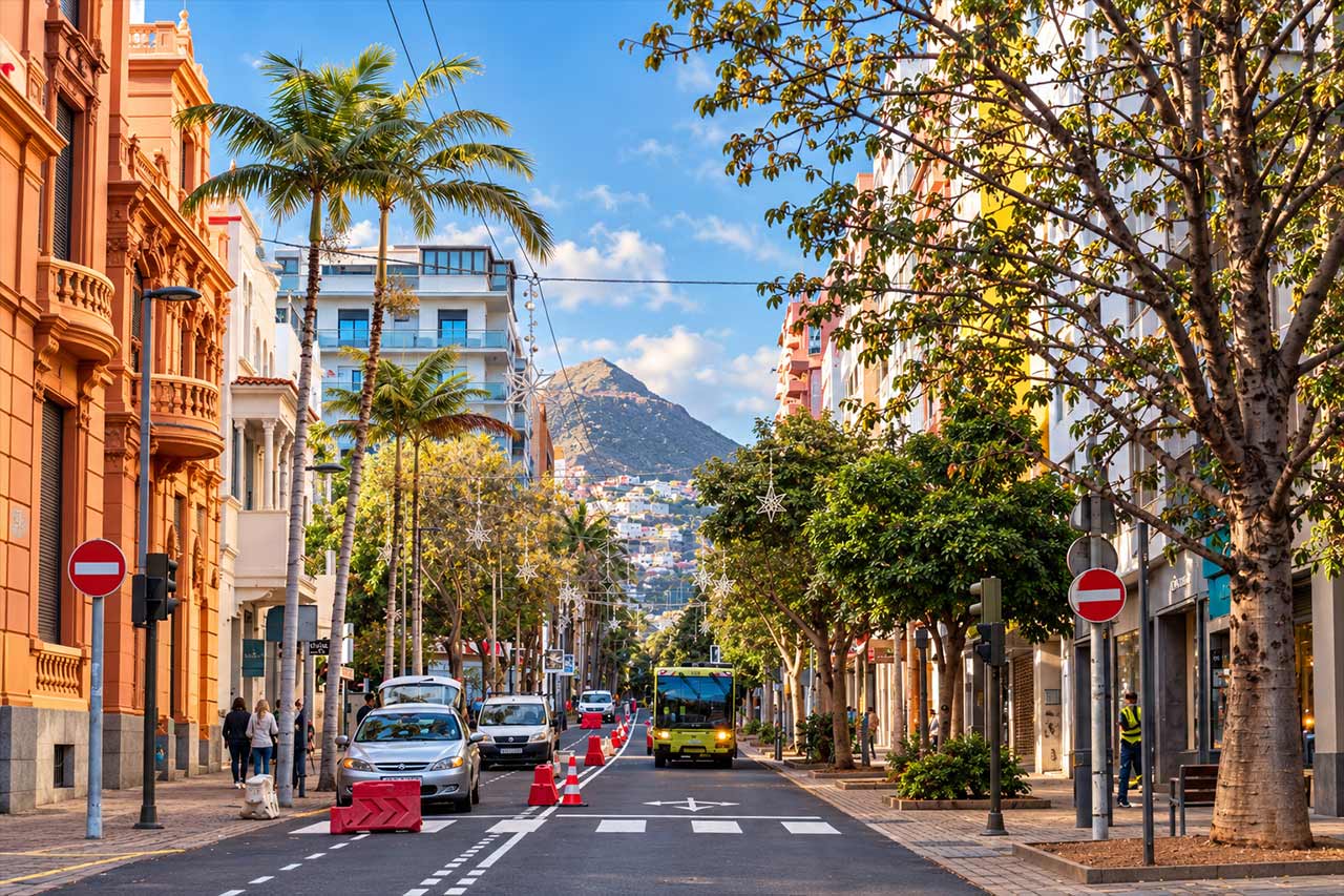 A Tenerife city street framed by the mountains of the north, visually marking the transition from the cultural stops in Santa Cruz and La Laguna toward the dramatic landscapes of Anaga.