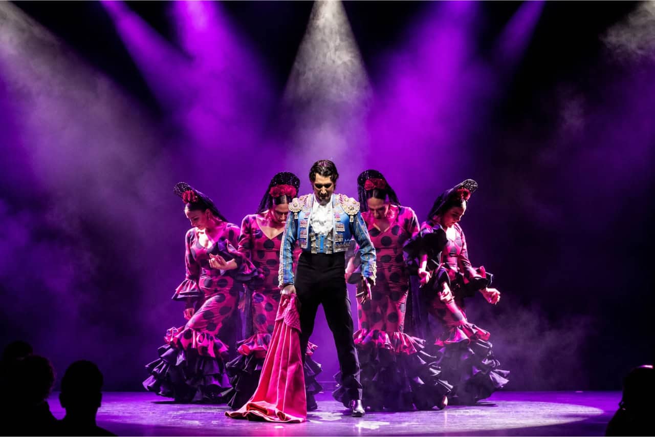 Flamenco dancers in colourful costumes performing at the Olé show in Costa Adeje