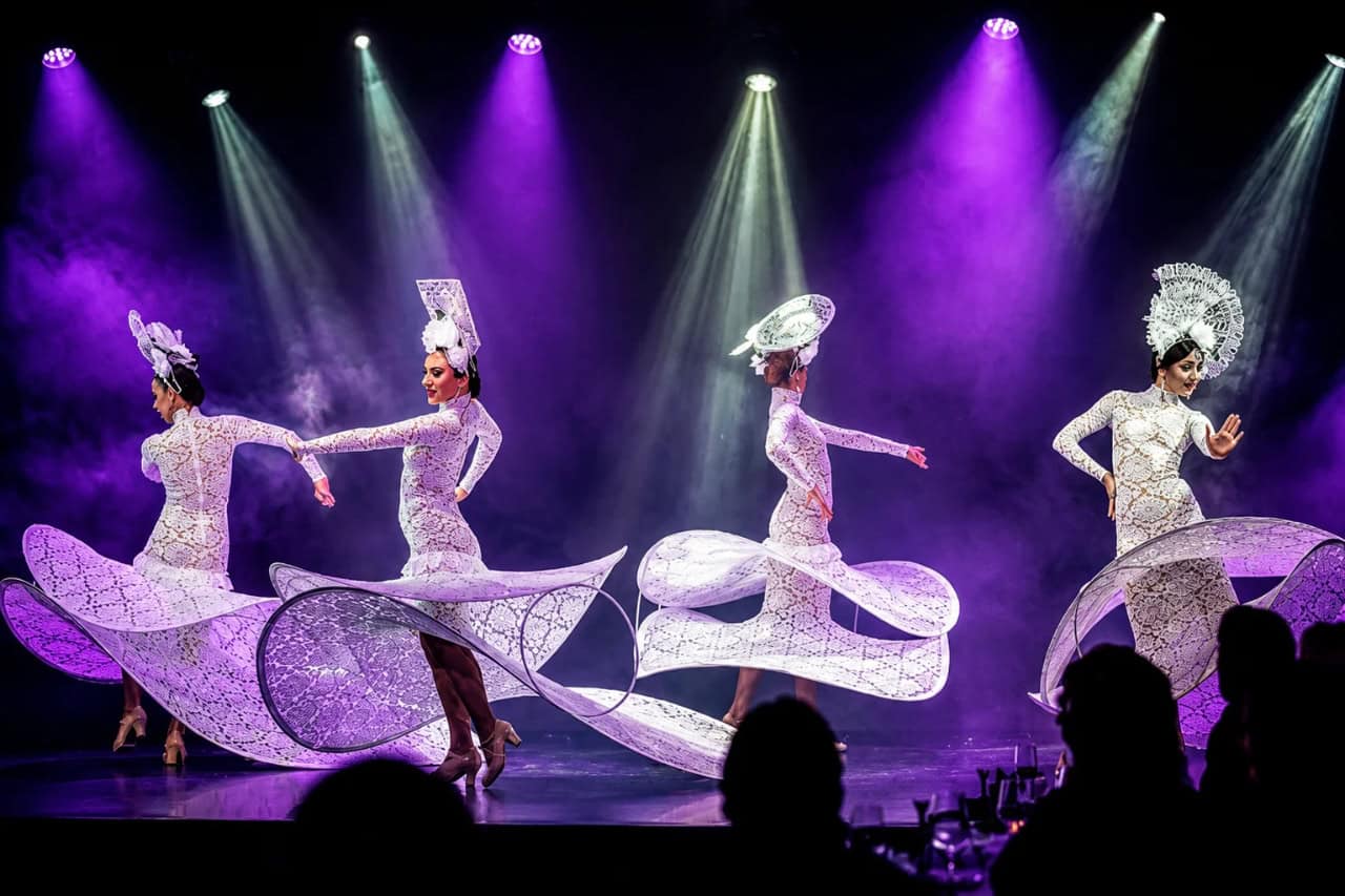 Dancers in elegant white costumes during a Spanish dance performance in Tenerife