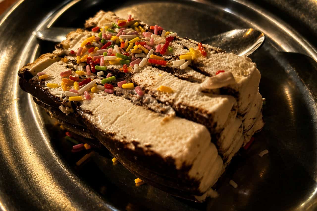 Layered cream and chocolate dessert with colourful sprinkles served during a medieval feast Tenerife dinner.
