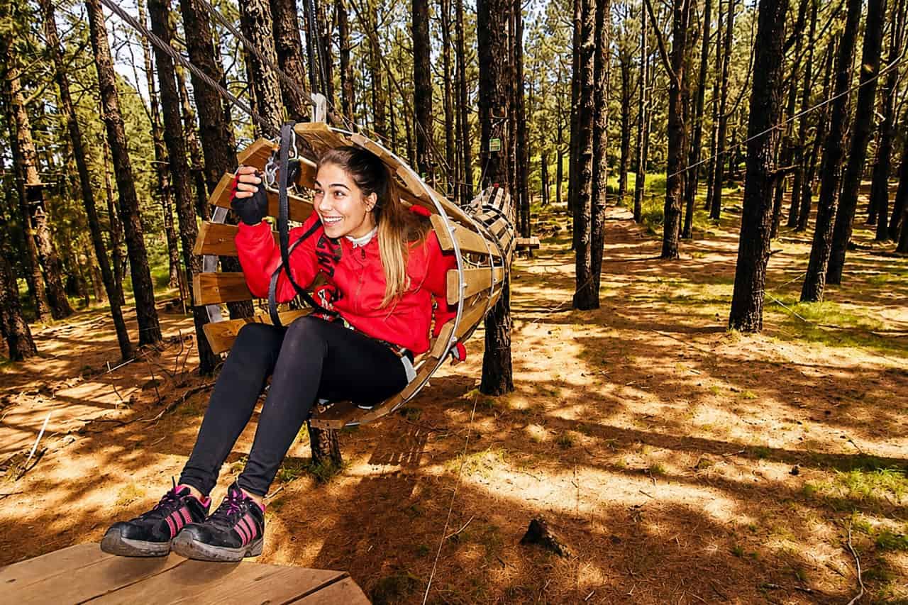 Zip line seat ride through the pine forest at Forestal Park