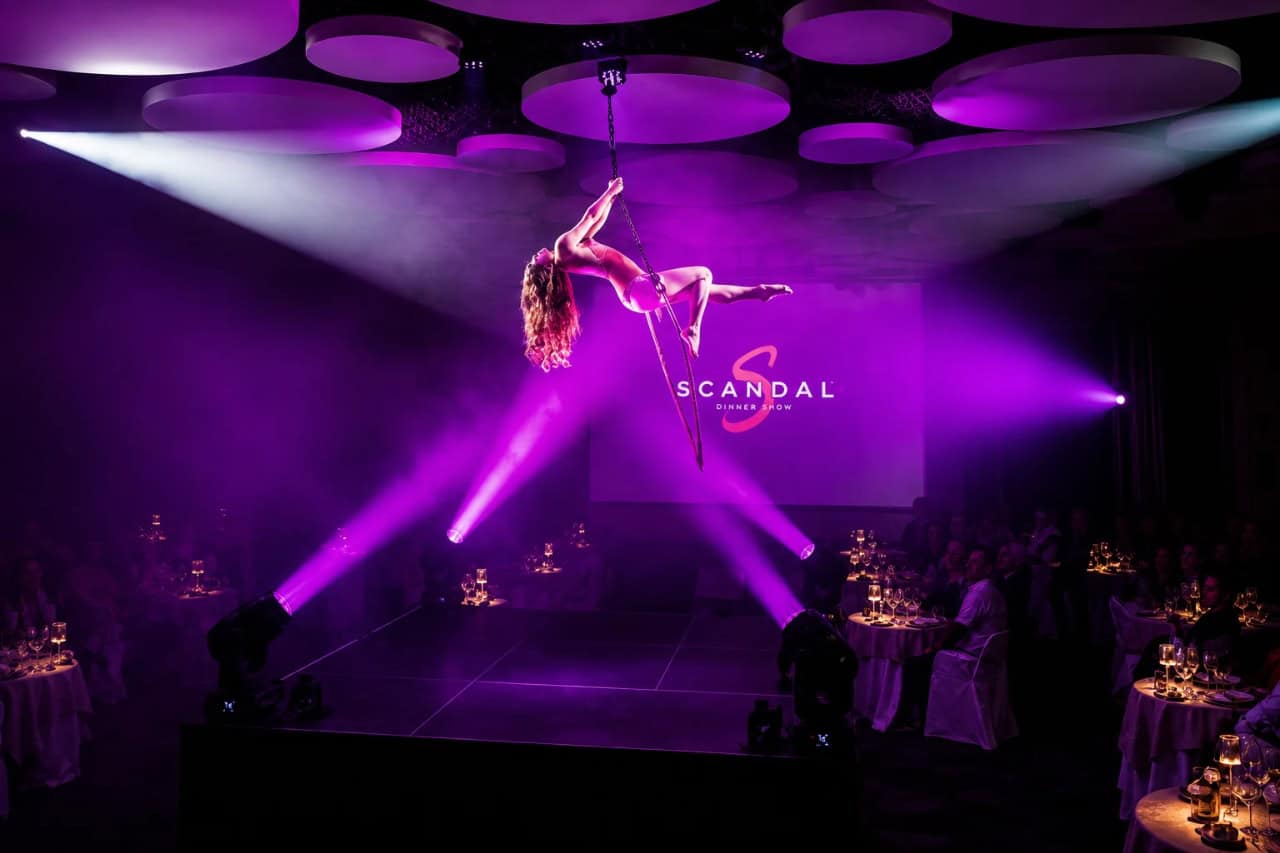 Aerial acrobat performing above the stage during an evening show in Costa Adeje