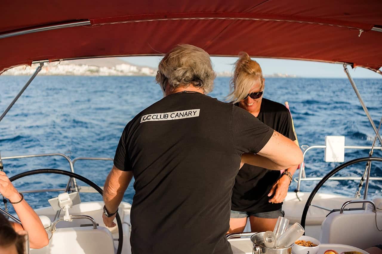 The Atlantic Star captain and crew member Estelle prepare refreshments for guests during the Tenerife whale-watching trip.
