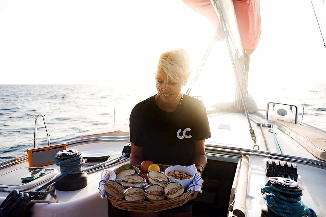 Crew member Estelle serves a basket of fresh sandwiches included with the Atlantic Star whale-watching tour in Tenerife.