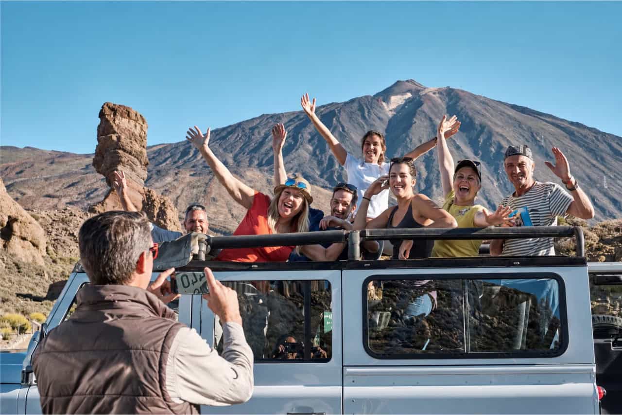 Guests enjoying an open-top Tamarán jeep safari through dramatic volcanic scenery