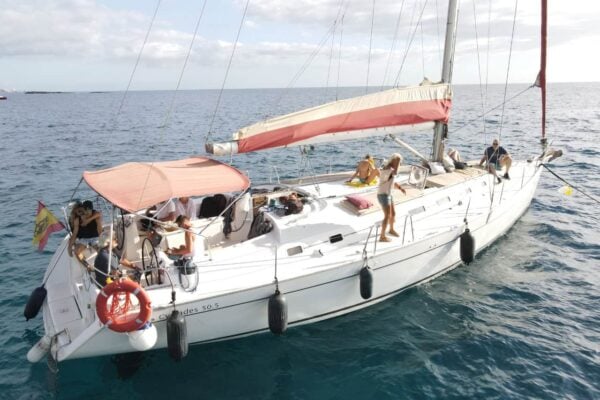 Private whale and dolphin watching boat in Tenerife with a small group relaxing on deck of a sailing yacht near Costa Adeje
