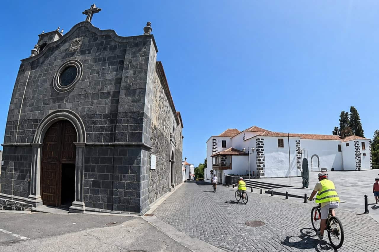 Guests cycling through a traditional Tenerife mountain village on the way down