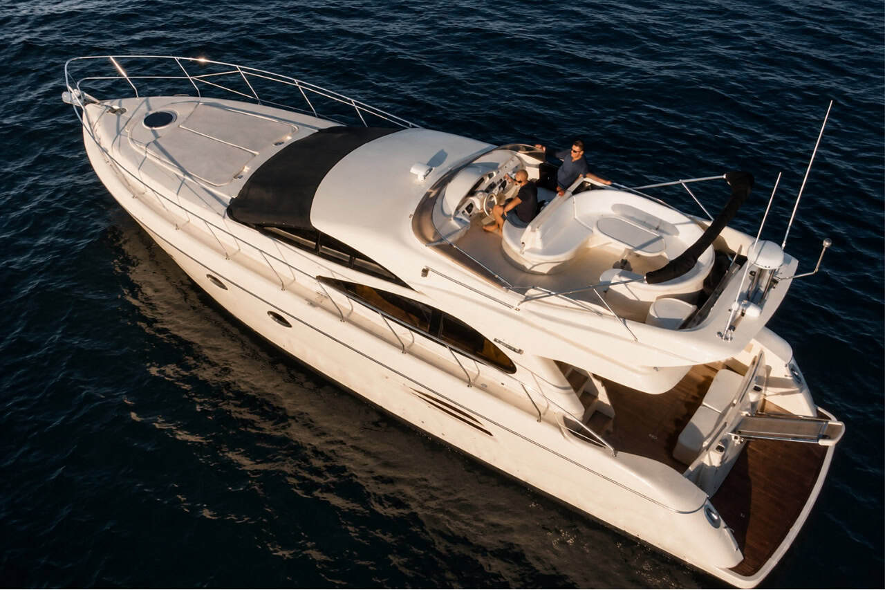 The Seaduction luxury motor yacht cruising in Tenerife’s Atlantic waters, featuring spacious outdoor seating, a flybridge and premium private charter facilities.