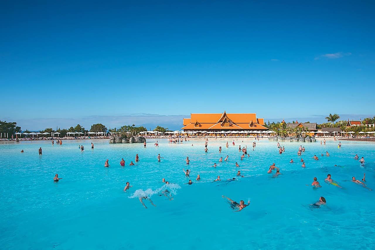 Siam Park VIP fast pass experience at Siam Beach with the large wave pool and Thai-style buildings