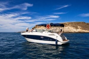 The Armani motor boat (8.6 metres) cruising along Tenerife's coastline during a private boat hire experience, featuring comfortable seating, sunbathing areas and crystal-clear Atlantic waters.