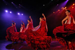 Live flamenco show at Tablao Flamenco Tenerife featuring talented dancers, vibrant red costumes and an authentic Spanish cultural experience.