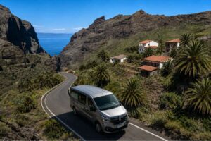 Private tour van overlooking the dramatic Masca Valley in West Tenerife, passing traditional Canarian houses, palm trees, volcanic mountains and scenic coastal roads.