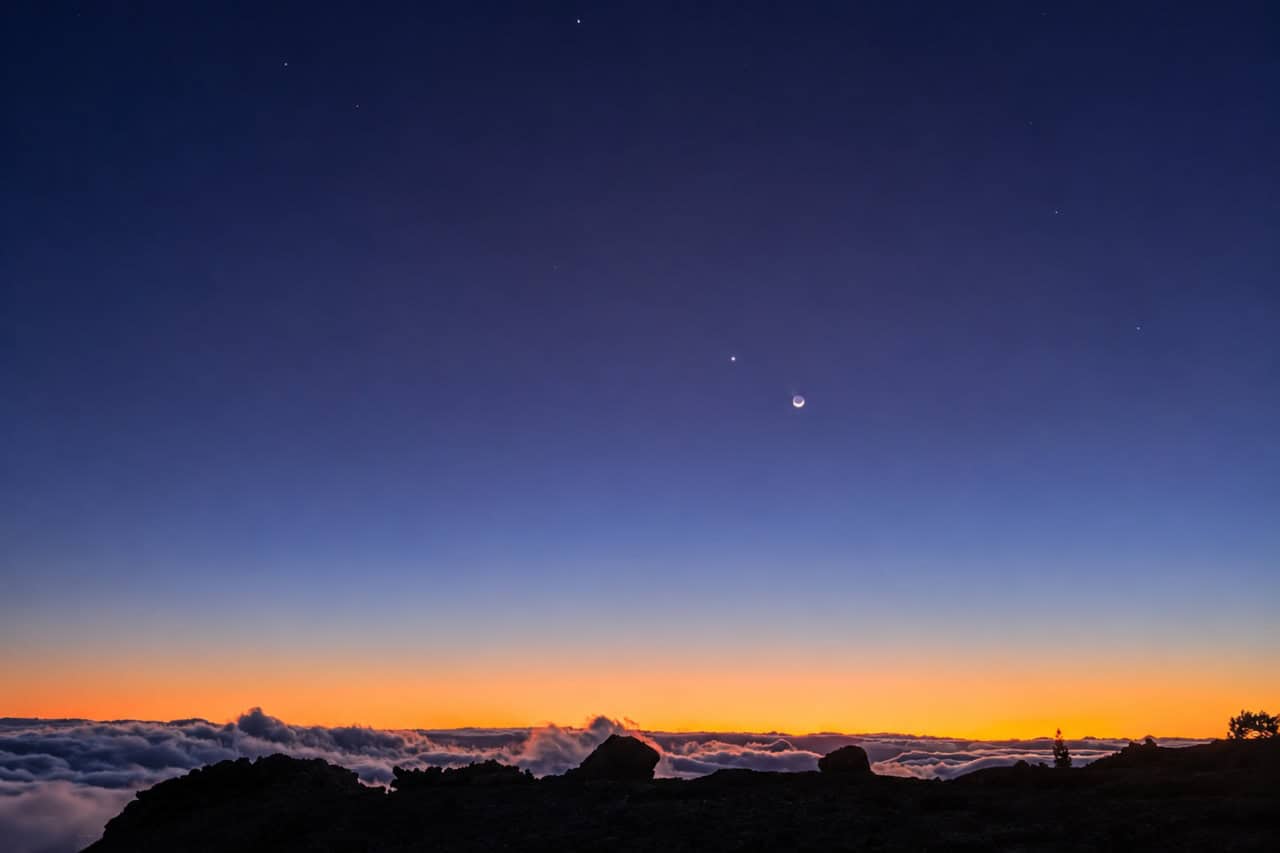Crescent moon above the clouds at twilight in Teide