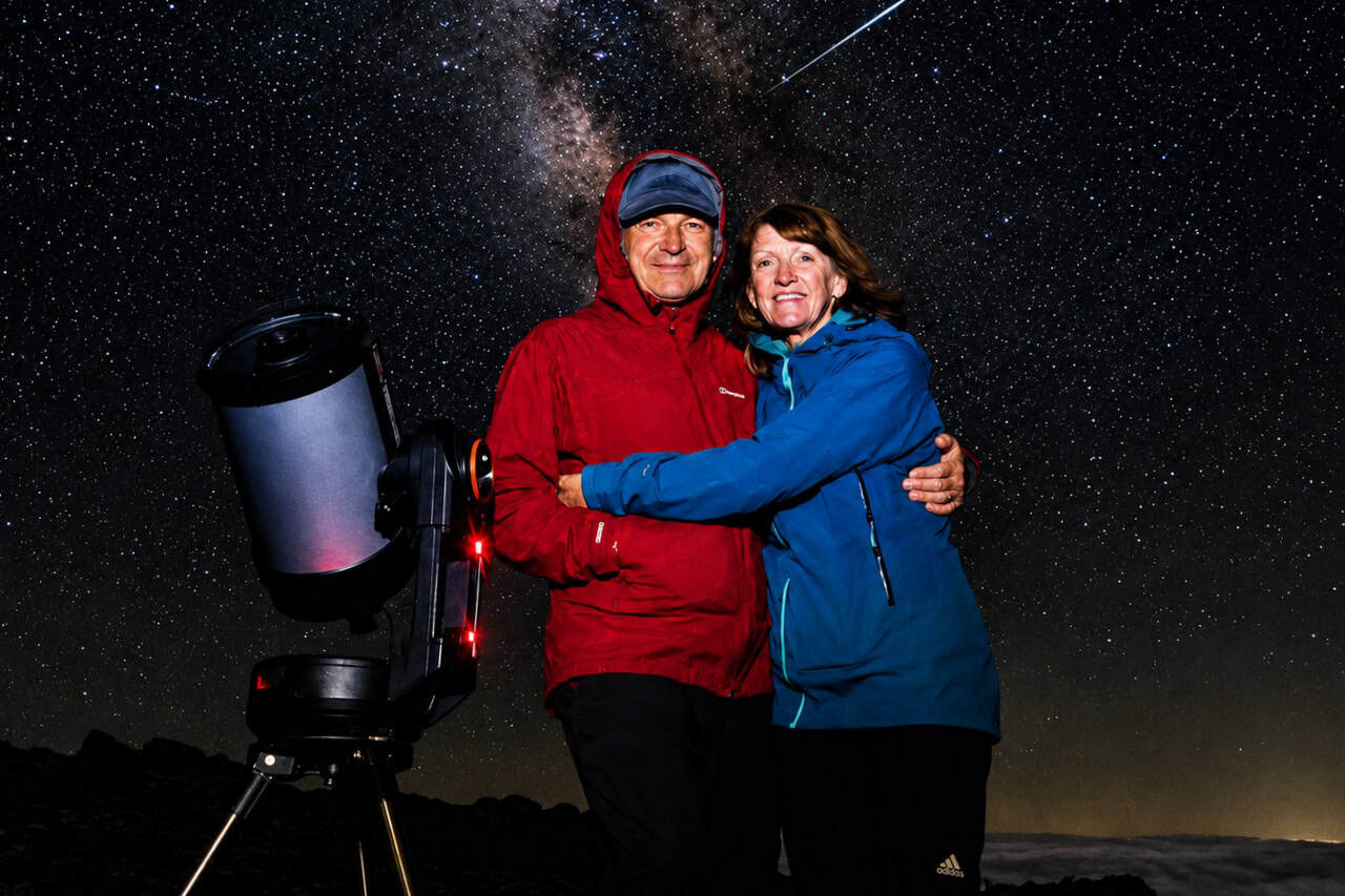 Couple beside their telescope on a private stargazing trip in Teide