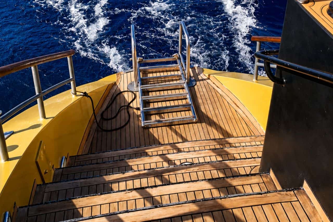 Stern swimming platform and ladder on Freebird Gold, where private groups can enter the Atlantic during a luxury company outing or corporate catamaran charter in Tenerife.