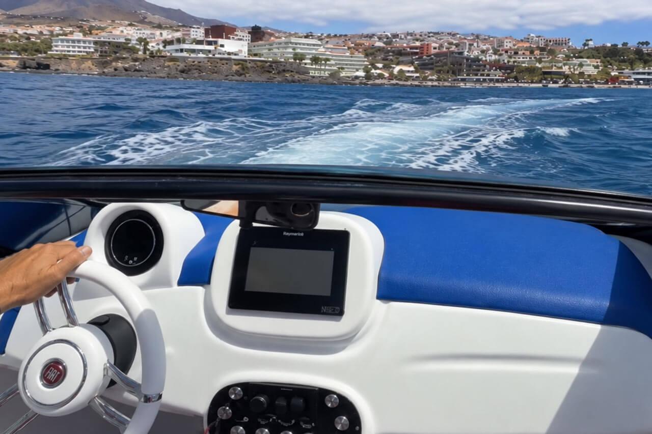 Driver view over the steering wheel of the car boat at sea