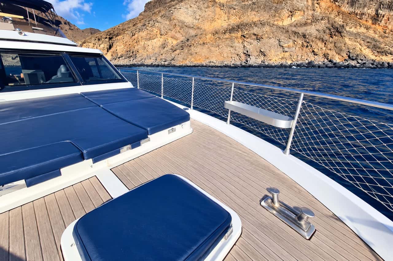 Blue M sun deck with the coastal cliffs near Puerto de Mogán behind