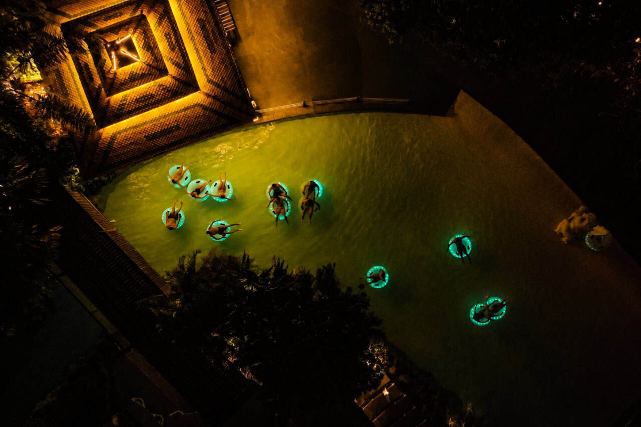 Guests on illuminated floating rings at Siam Park Night