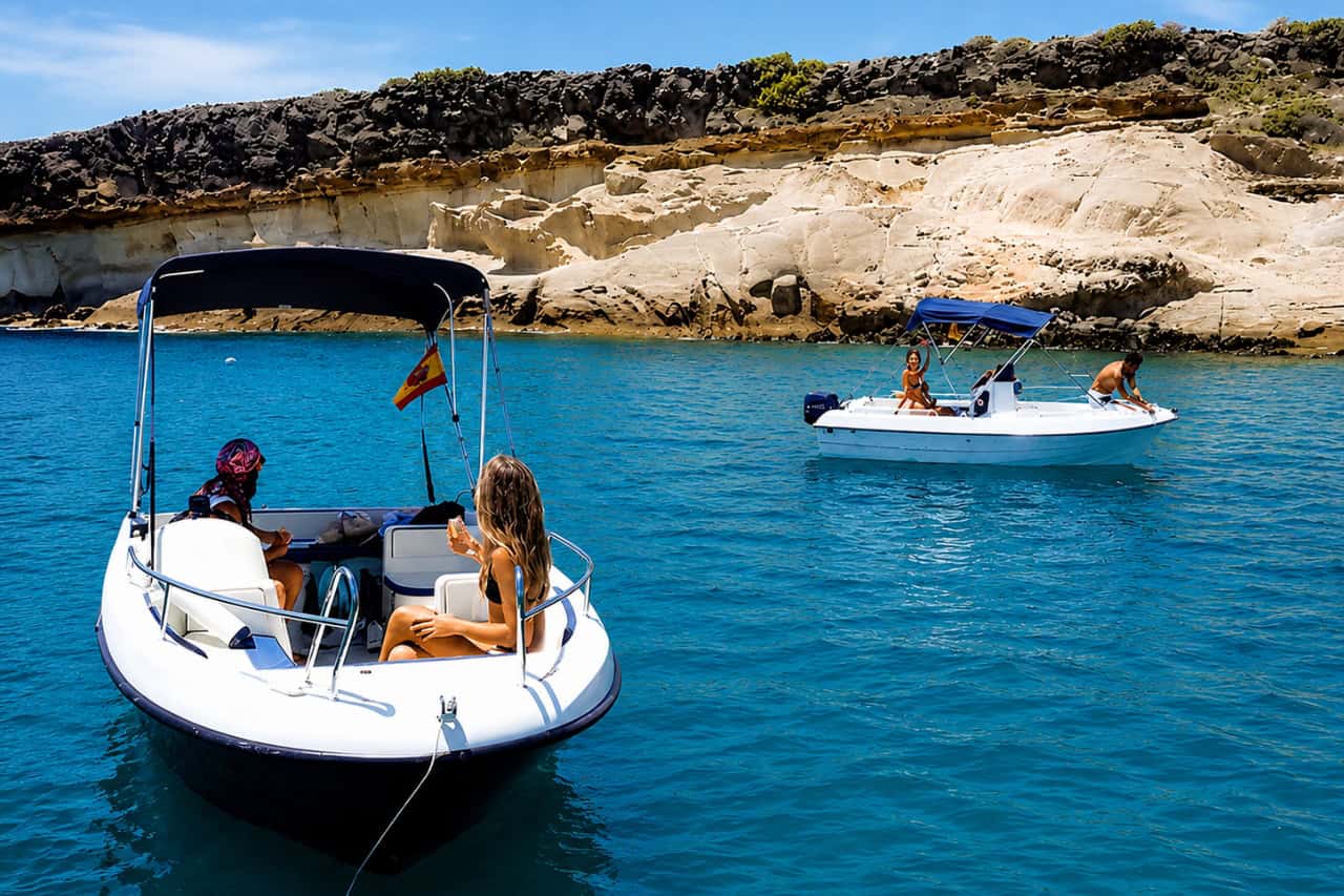 Twee kleine bootjes bij een rotsachtige baai op Tenerife