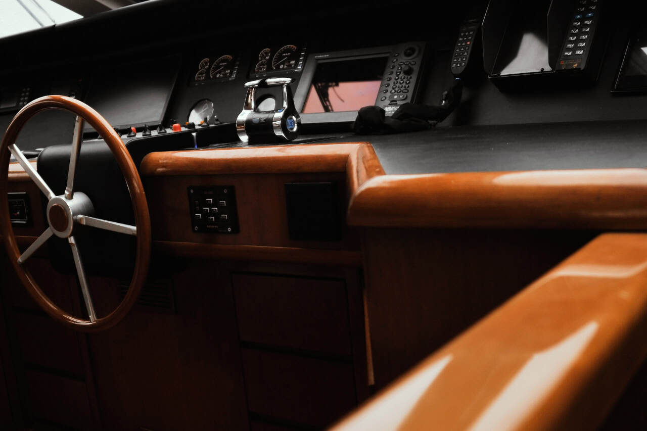 Professional helm and navigation controls aboard a crewed luxury yacht for sailing holidays in the Canary Islands.