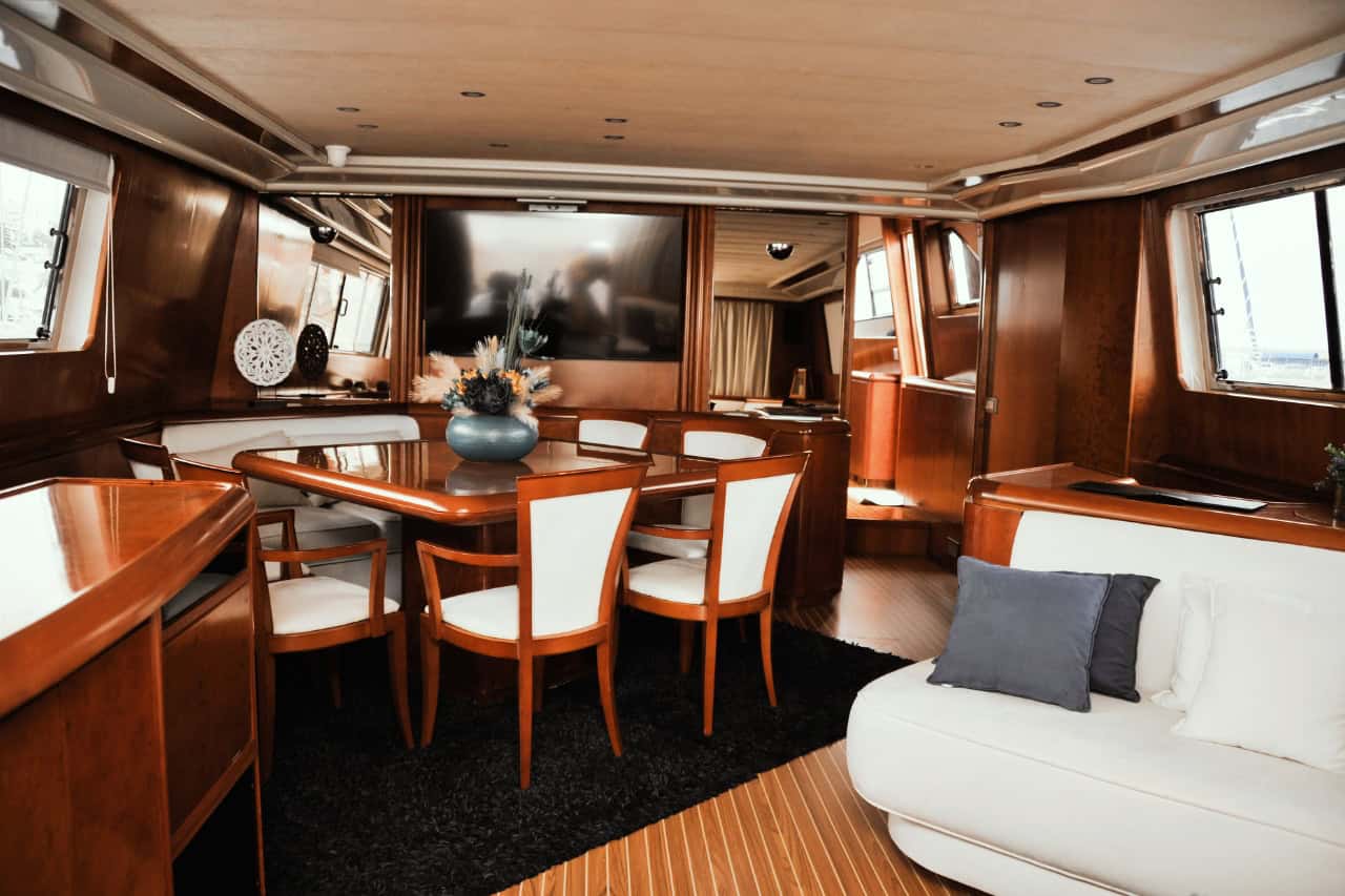 Spacious luxury yacht interior with dining area and lounge for a private yacht holiday in the Canary Islands.