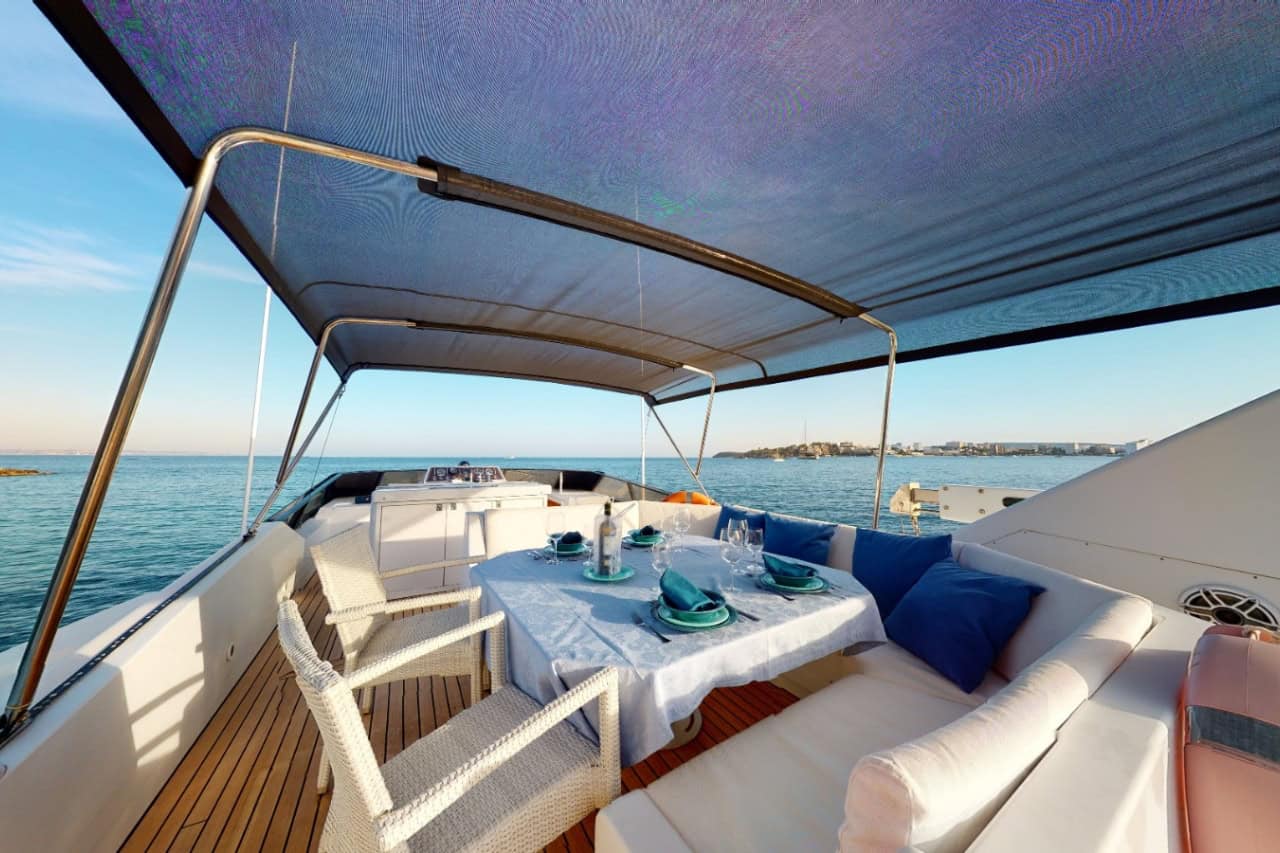 Covered outdoor dining area aboard a private luxury yacht for relaxing meals during a Canary Islands yacht vacation.