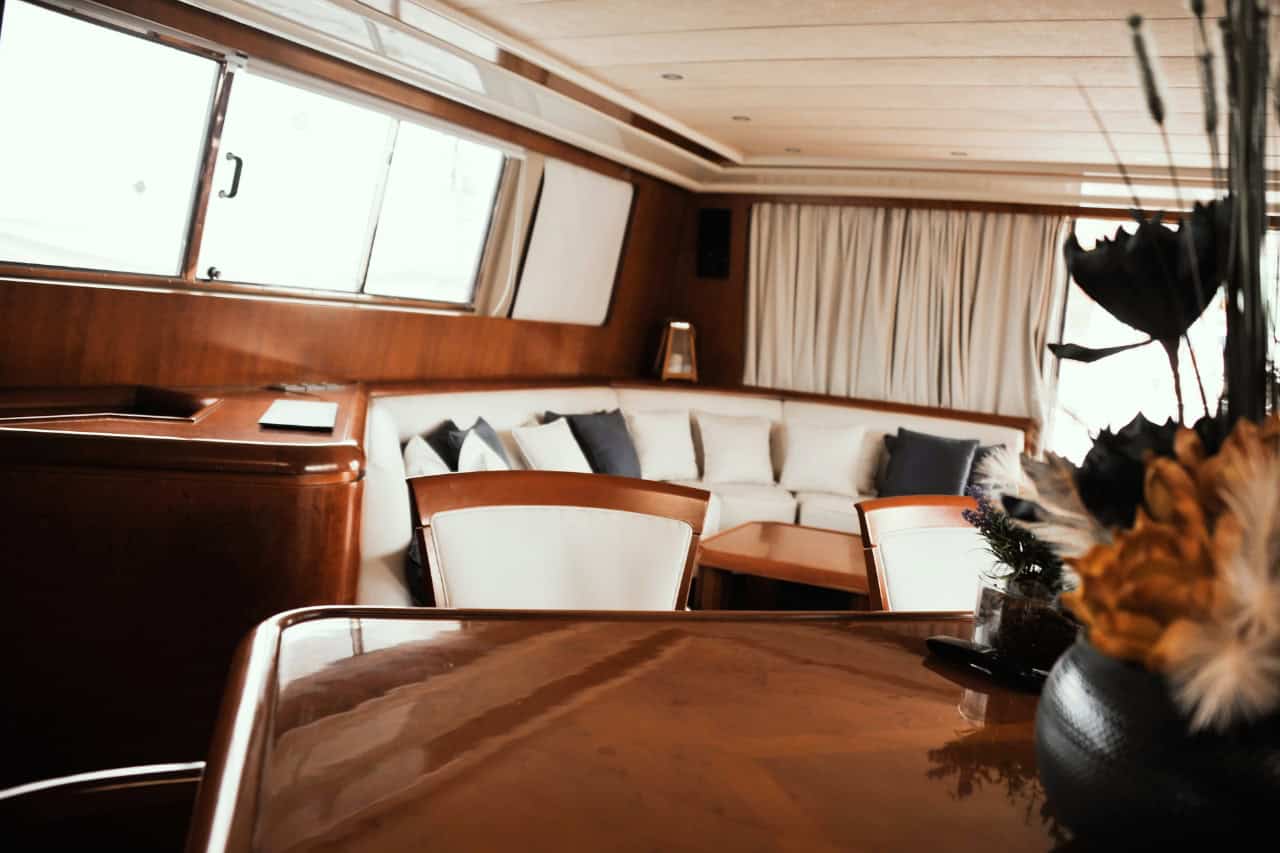 Elegant living and dining area aboard a private luxury yacht for island hopping in the Canary Islands.