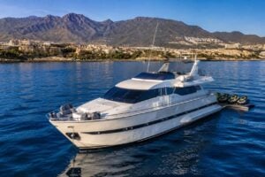 Exclusive private yacht in Tenerife with jet skis lined up behind the vessel, combining a luxury yacht charter with premium water sports.