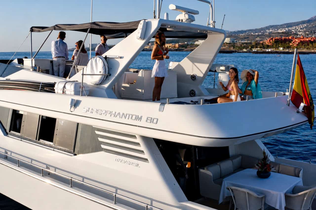 Guests relaxing on the upper deck during a VIP yacht charter in Tenerife, with spacious outdoor areas designed for exclusive private groups and celebrations.