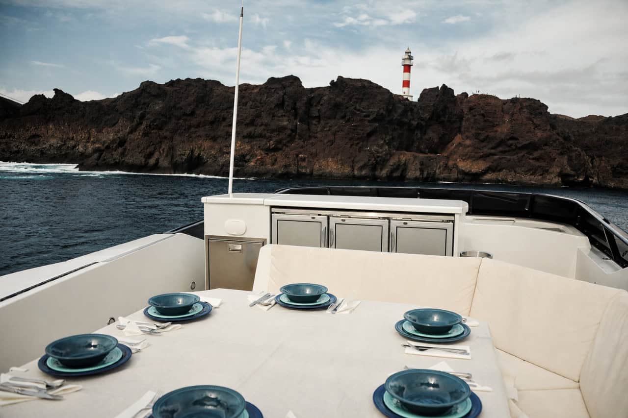 Private outdoor dining deck aboard the Rockstar luxury yacht in Tenerife, prepared for an exclusive meal and premium ocean experience.