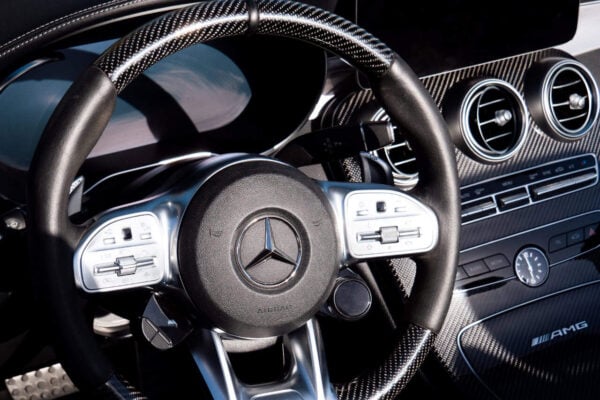 Интерьер Mercedes C63S AMG с приборной панелью из углеродного волокна и рулевым колесом AMG с элементами управления.