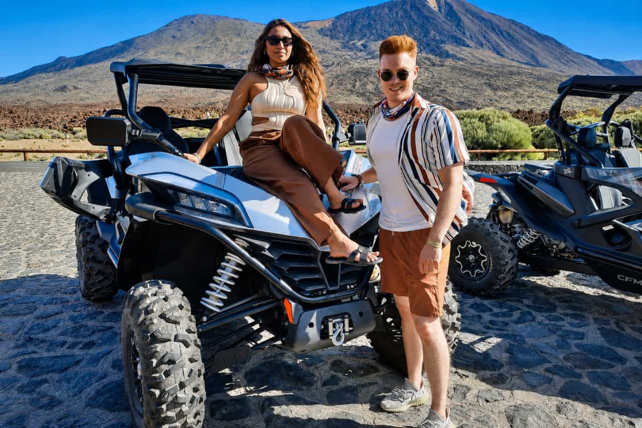Two riders posing beside an off-road buggy with Mount Teide in the background during a Tenerife buggy tour.