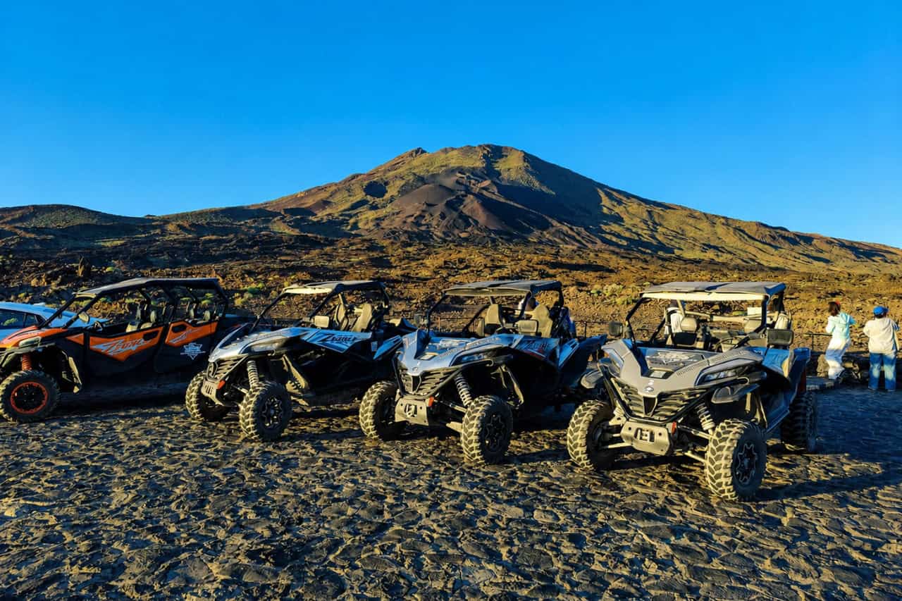 Lineup of off-road buggies parked in the volcanic landscape of Teide National Park in Tenerife.