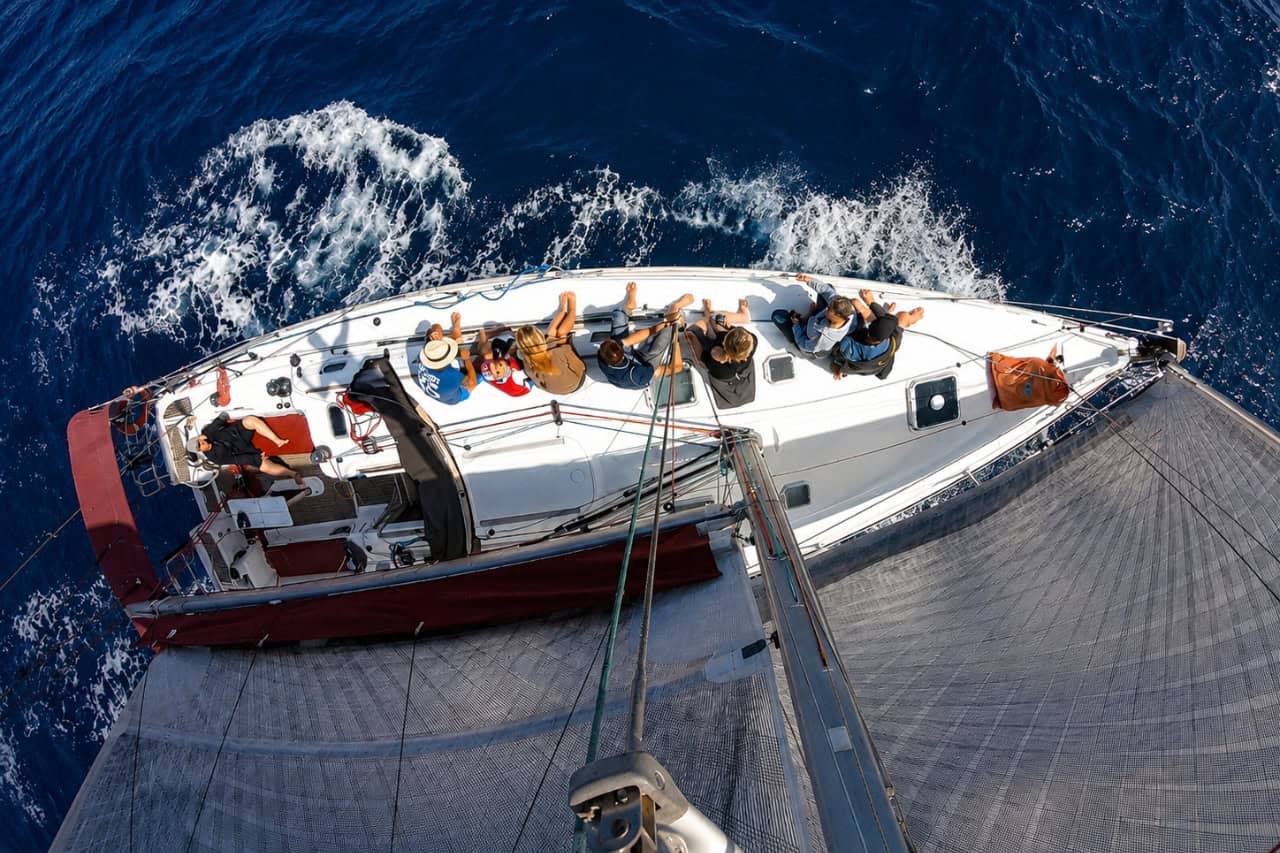 Overhead view of guests relaxing aboard a sailing yacht near Fuerteventura