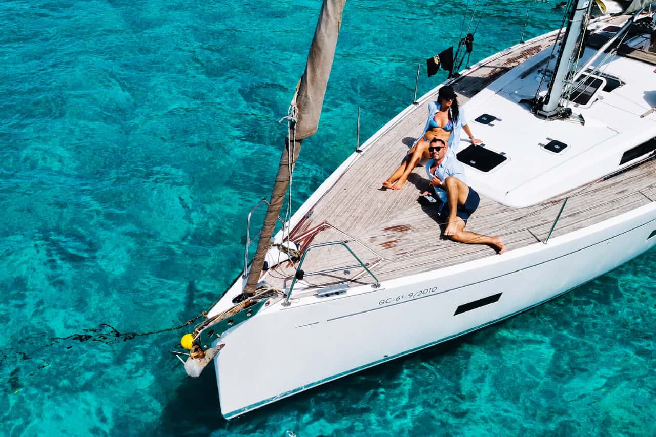 Couple relaxing on the deck of the Flounder sailing boat near Morro Jable
