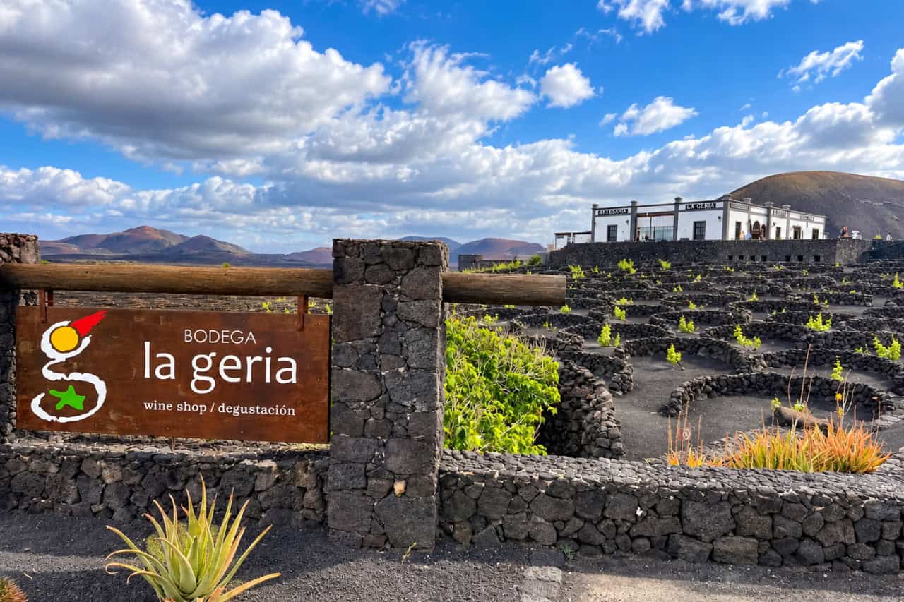 Bodega La Geria winery sign above vines growing in black volcanic soil in Lanzarote