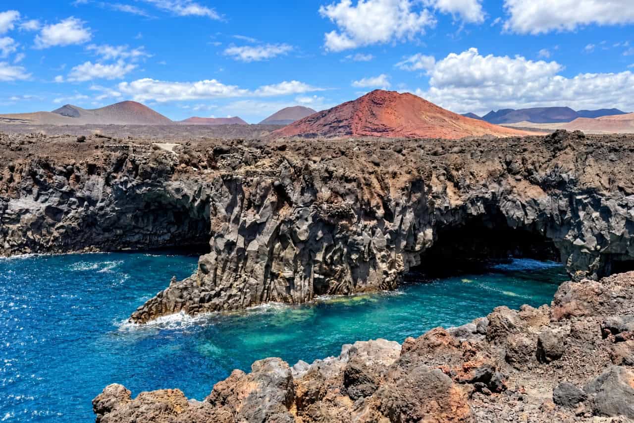 Turquoise Atlantic water framed by black volcanic cliffs at El Golfo in Lanzarote