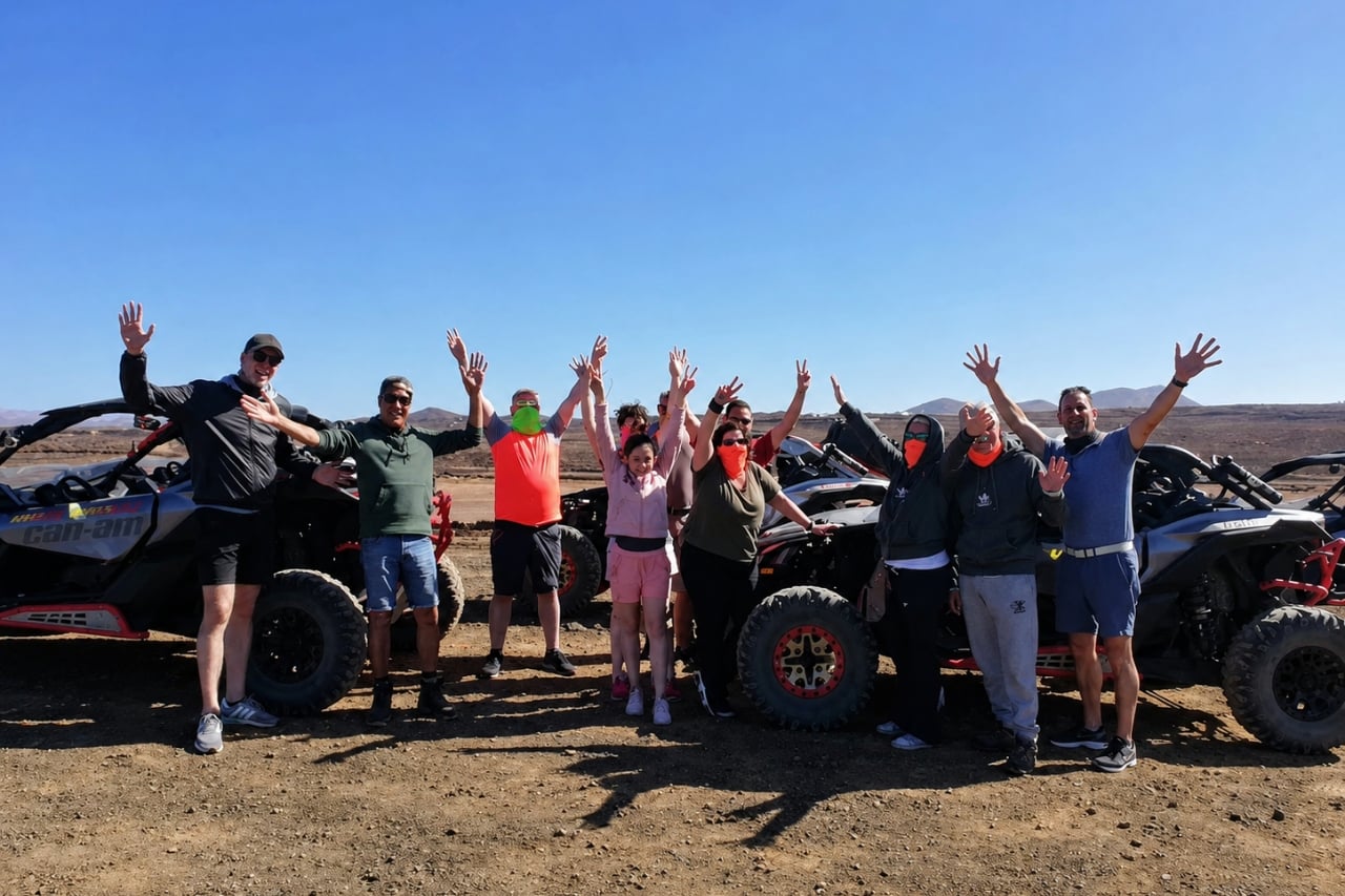 Group of guests celebrating beside off-road buggies during a volcanic buggy tour in Lanzarote