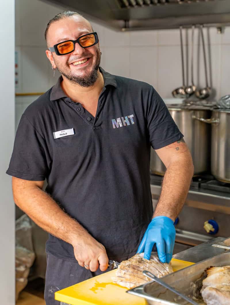 MHT staff member preparing dinner for drag show Lanzarote comedy dinner show Puerto del Carmen
