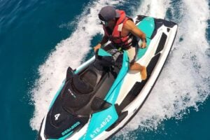 Rider enjoying a jet ski rental in Morro Jable, Fuerteventura, speeding across clear blue Atlantic waters with Club Canary.