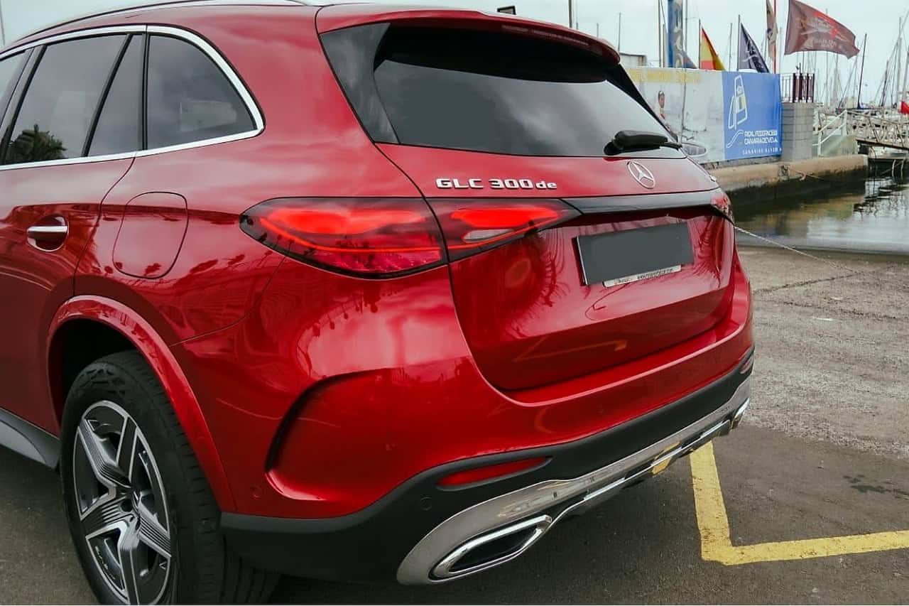 Rear three quarter view of the red Mercedes GLC 300 de with the badge on the tailgate