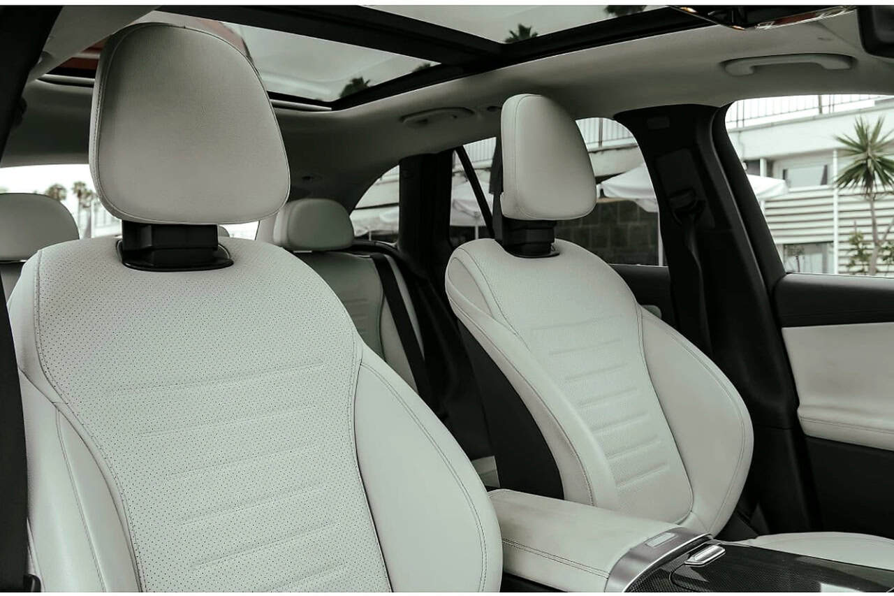 Light leather seats and panoramic glass roof inside the Mercedes GLC 300 de