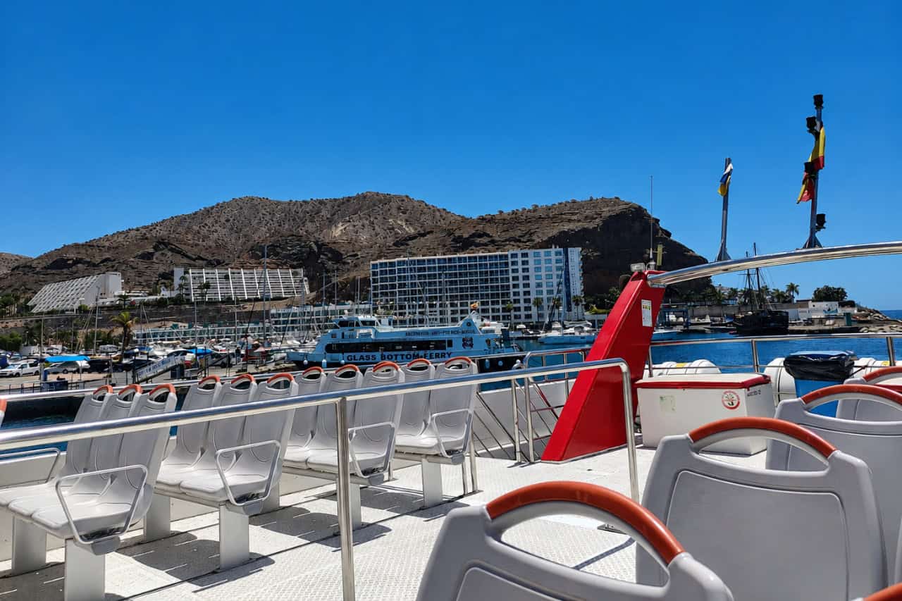 Open deck seating on the Multiacuatic catamaran docked in Puerto Rico harbour, Gran Canaria, before a dolphin and whale watching trip.