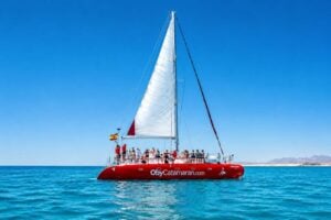 White sail of a red catamaran during a boat party off the coast of Fuerteventura.